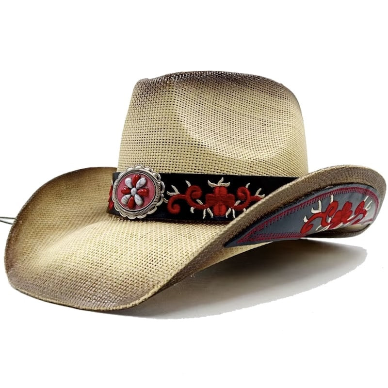 A straw cowboy hat with a black band decorated with red embroidery and a silver and red medallion.