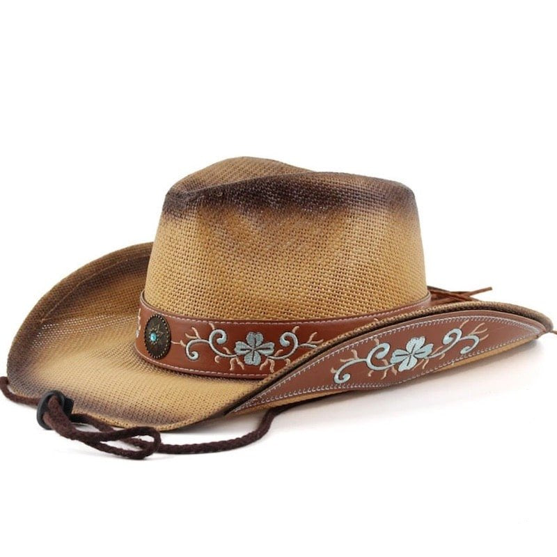 A straw cowboy hat with an embroidered leather band.
