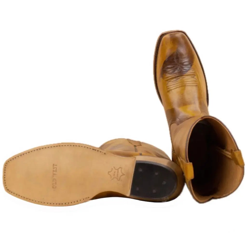 A pair of tan leather cowboy boots.