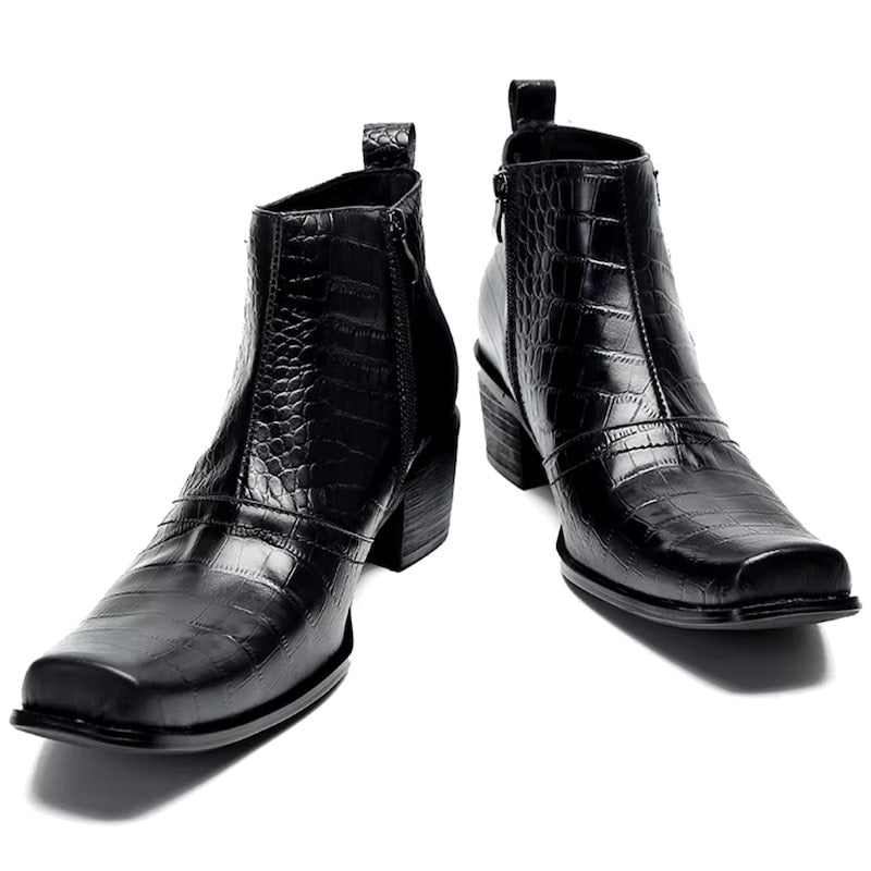Two black leather ankle boots with a reptile pattern.