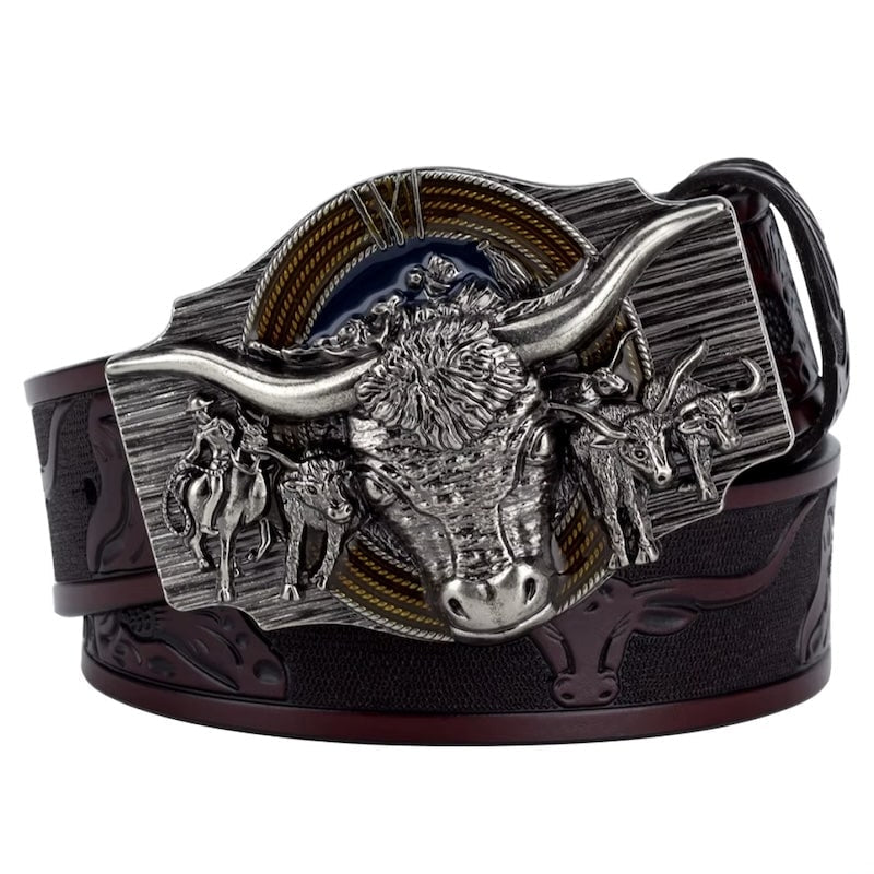 Close-up of a brown leather belt with an ornate silver buckle featuring a bull head and cowboy scene.