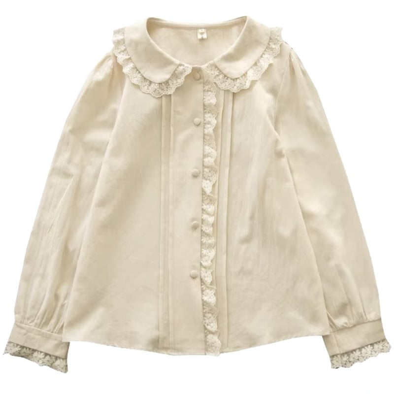 Cream-colored blouse with lace trim, long sleeves.
