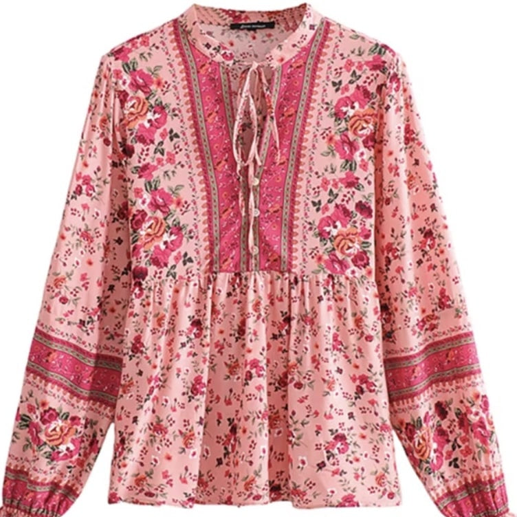 Pink floral print long-sleeved blouse with a neck tie.
