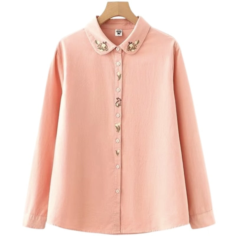Peach-colored button-down shirt with embroidered collar and buttons.