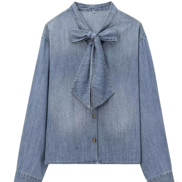 Light blue denim blouse with a bow.
