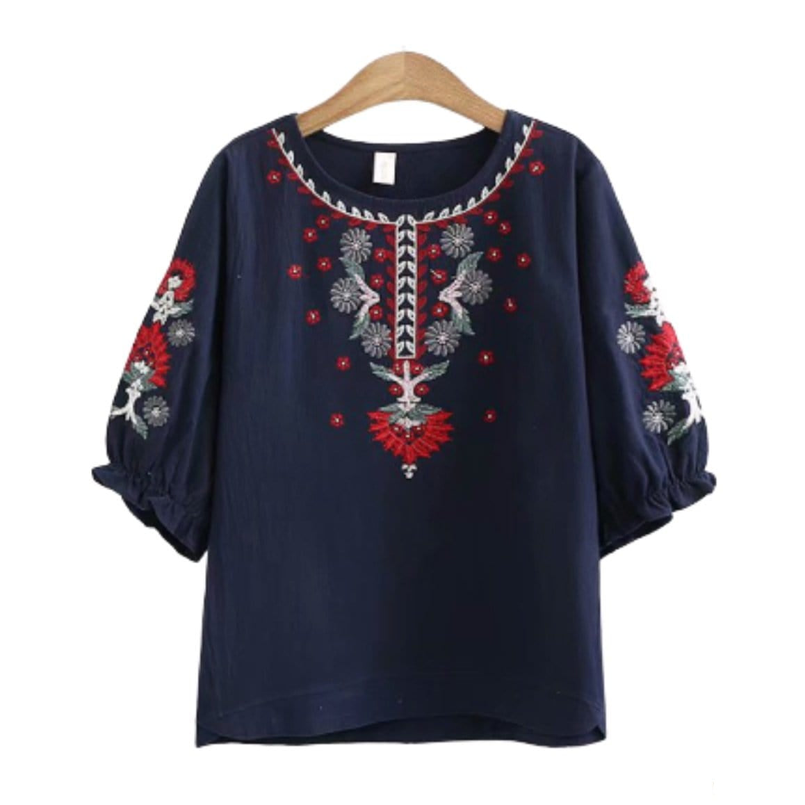 Dark blue embroidered blouse on hanger.
