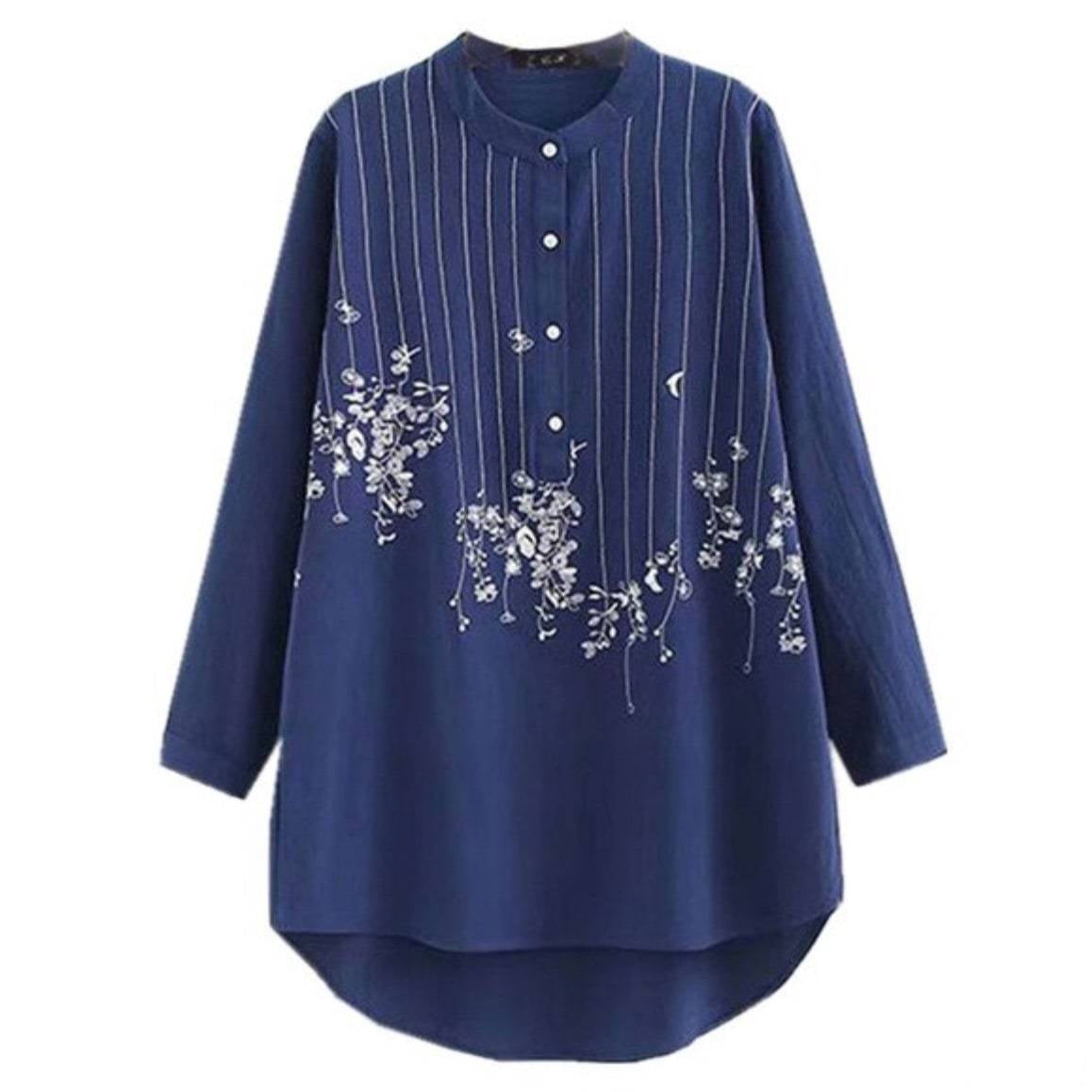 Long-sleeved blue tunic shirt with white floral and striped design. 
