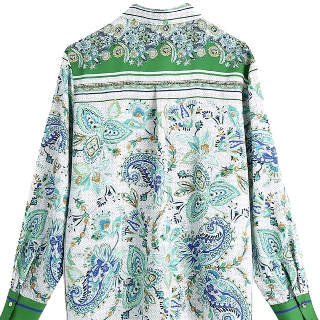 White long-sleeved shirt with blue and green paisley pattern and green accents.

