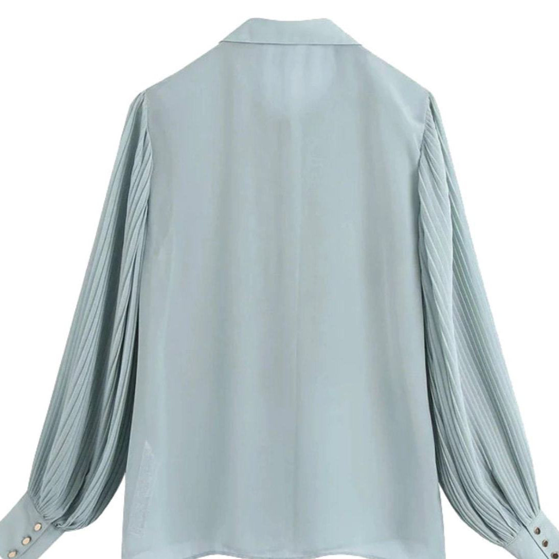 Light blue chiffon blouse with pleated sleeves.