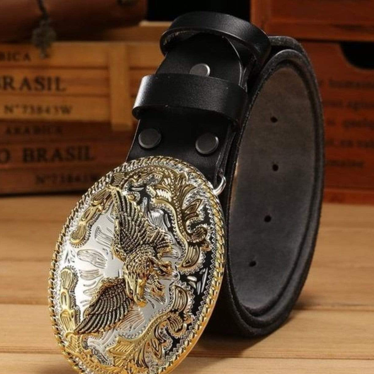 Black leather belt with large, ornate silver and gold eagle buckle.

