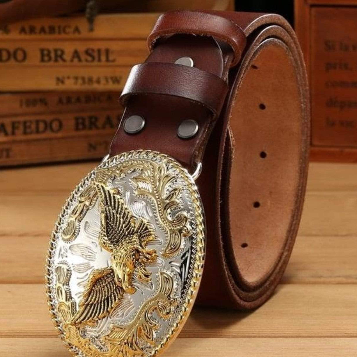 Brown leather belt with a silver and gold eagle buckle.