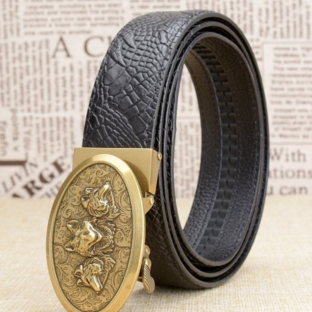 Black leather belt with a gold buckle featuring wolf designs.