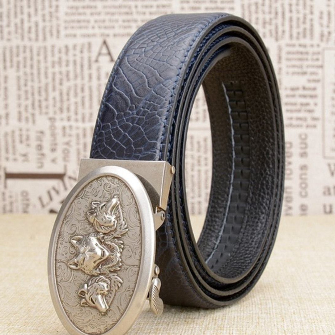 Blue textured leather belt with silver buckle featuring three wolf heads.
