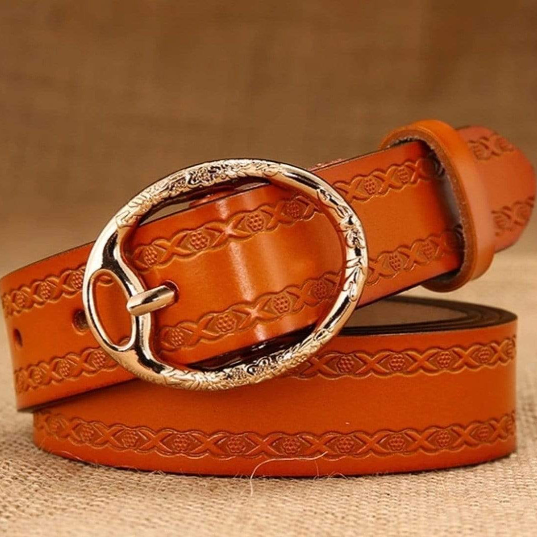 Tan leather belt with silver floral buckle.