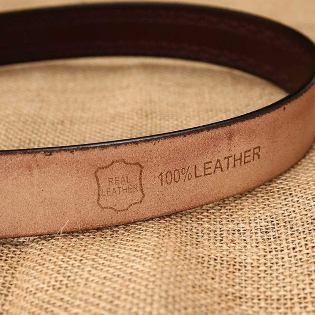 Close-up of a brown leather belt with "Real Leather" and "100% Leather" stamped on it.