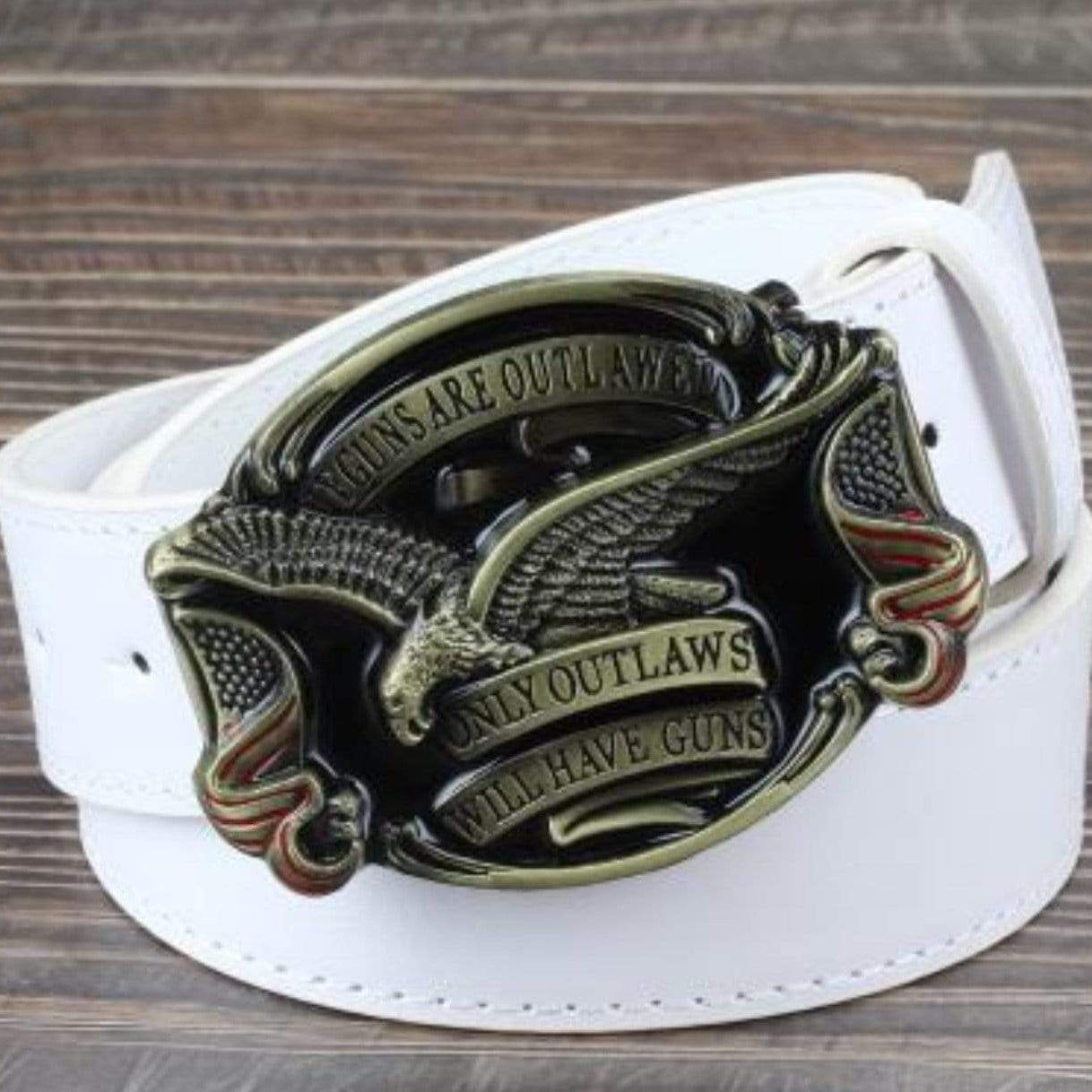 White belt with an ornate, gold-toned buckle featuring an eagle and the words "Guns Are Outlawed, Only Outlaws Will Have Guns".
