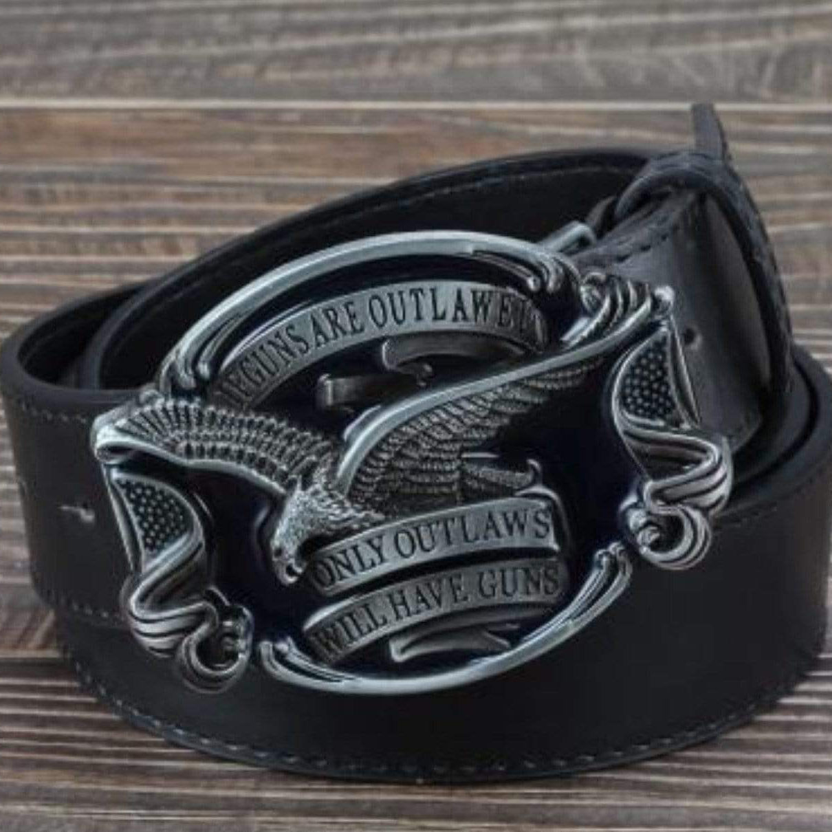 Black leather belt with silver eagle buckle. The buckle has text that reads "if guns are outlawed, only outlaws will have guns."
