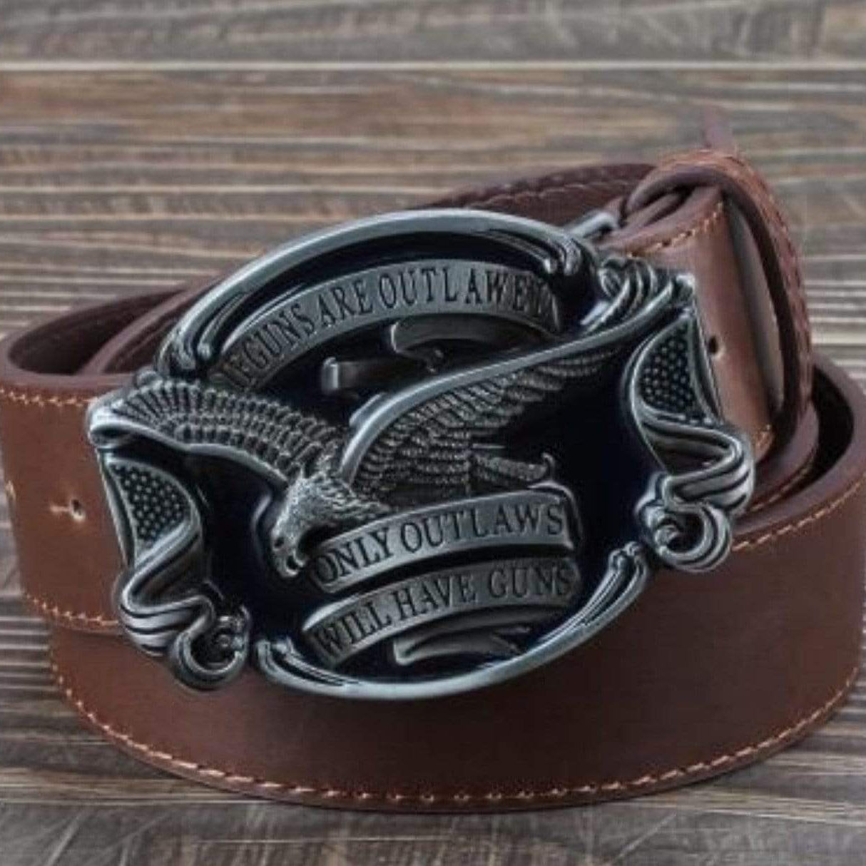 Brown leather belt with decorative buckle. 
