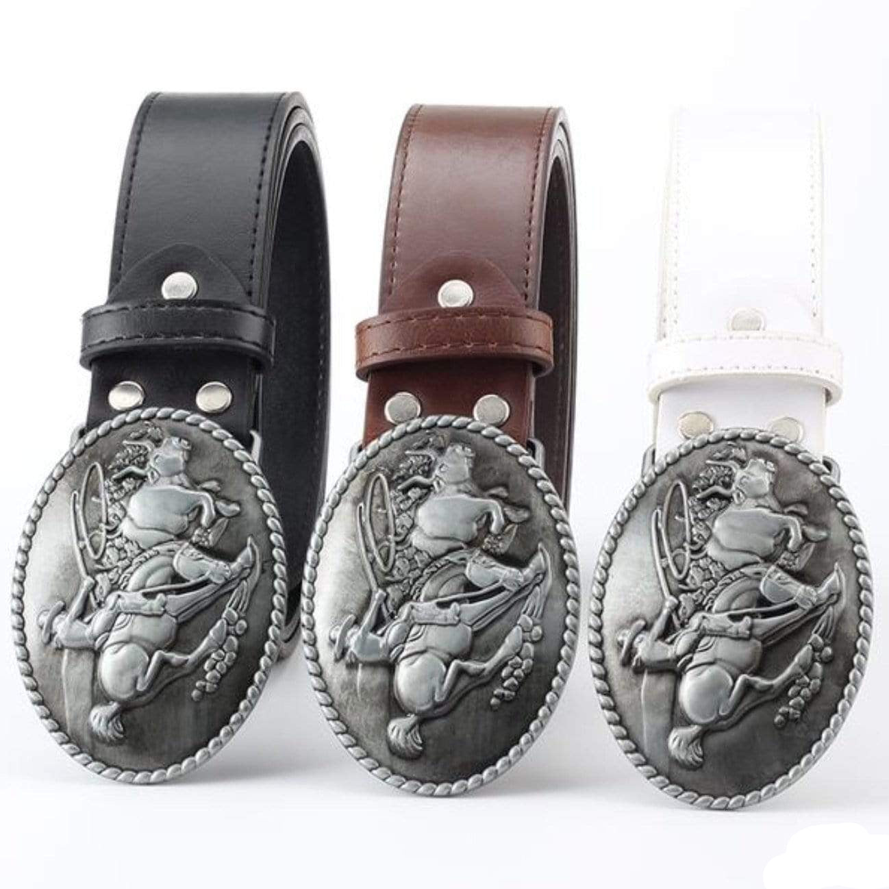 Three belts with oval buckles, black, brown, and white. The buckles feature a cowboy riding a horse.