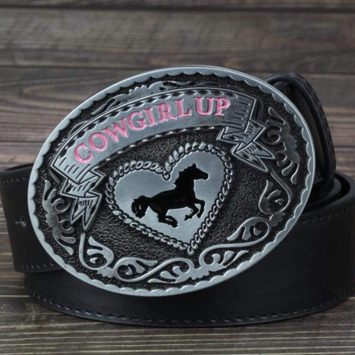 Black leather belt with a silver belt buckle. The buckle features pink "Cowgirl Up" text, a heart shape, and a horse silhouette.