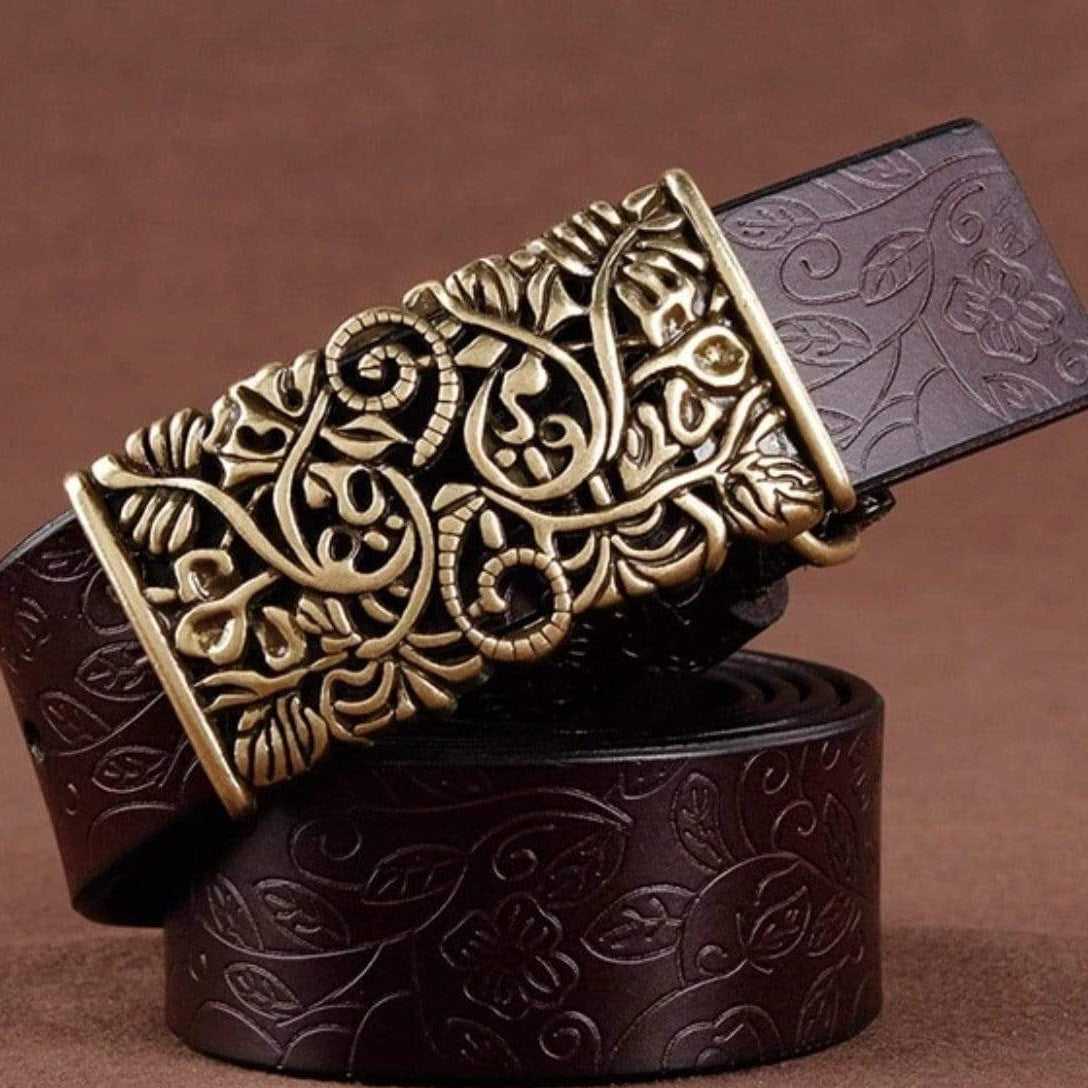 Brown leather belt with ornate gold buckle.