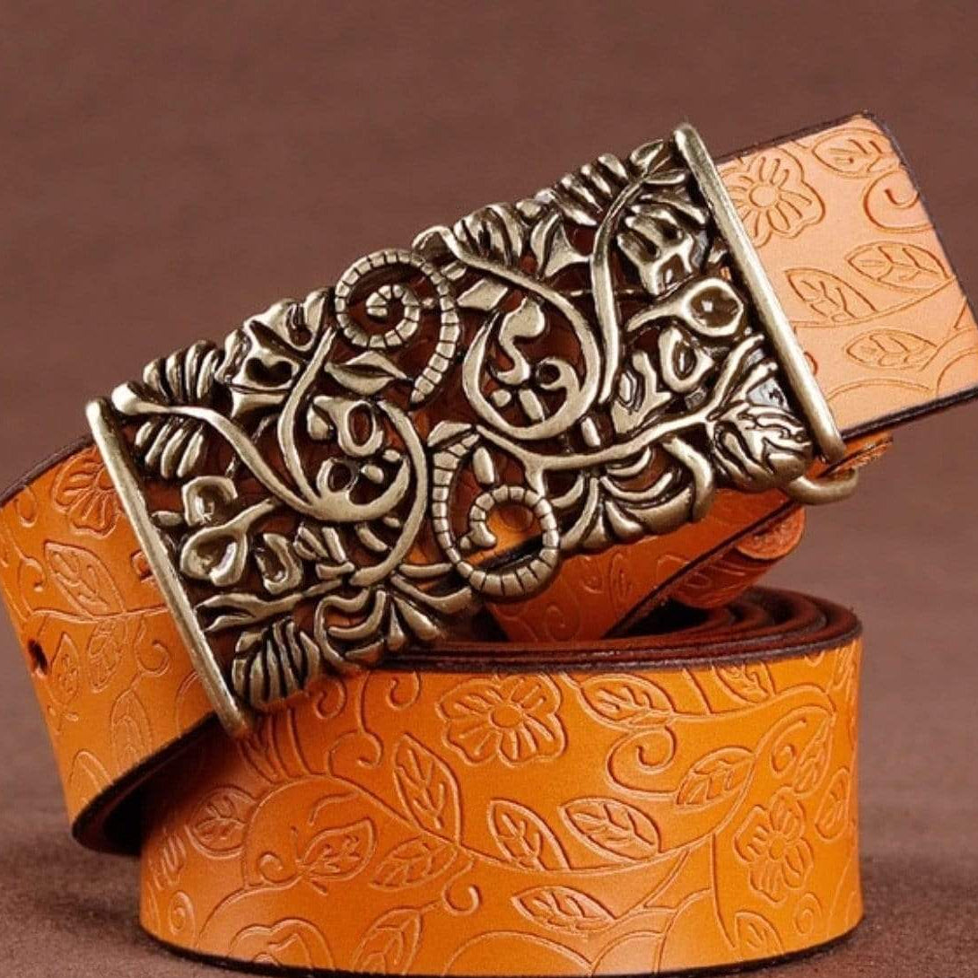 Embossed orange leather belt with ornate metal buckle.