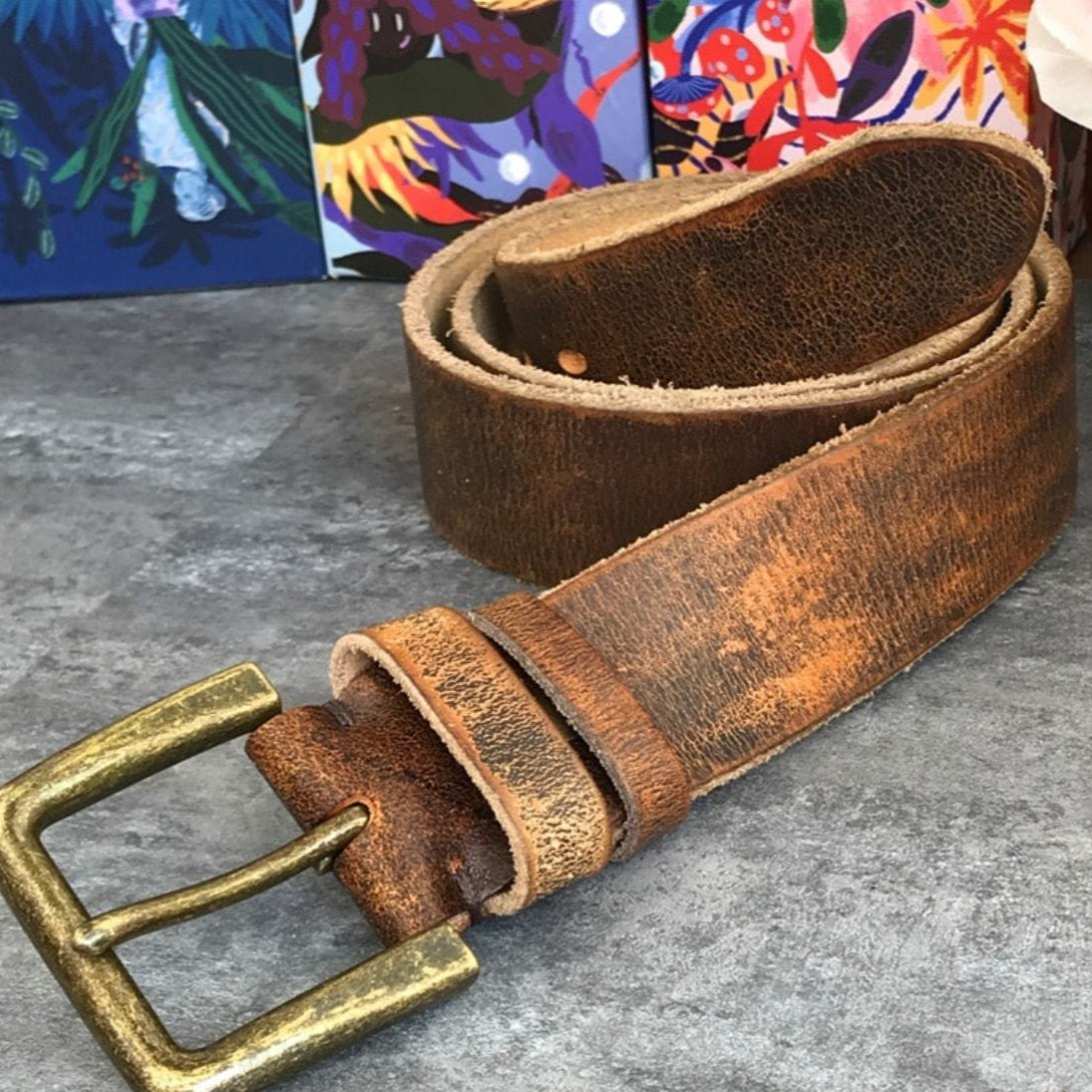 Distressed brown leather belt with brass buckle.
