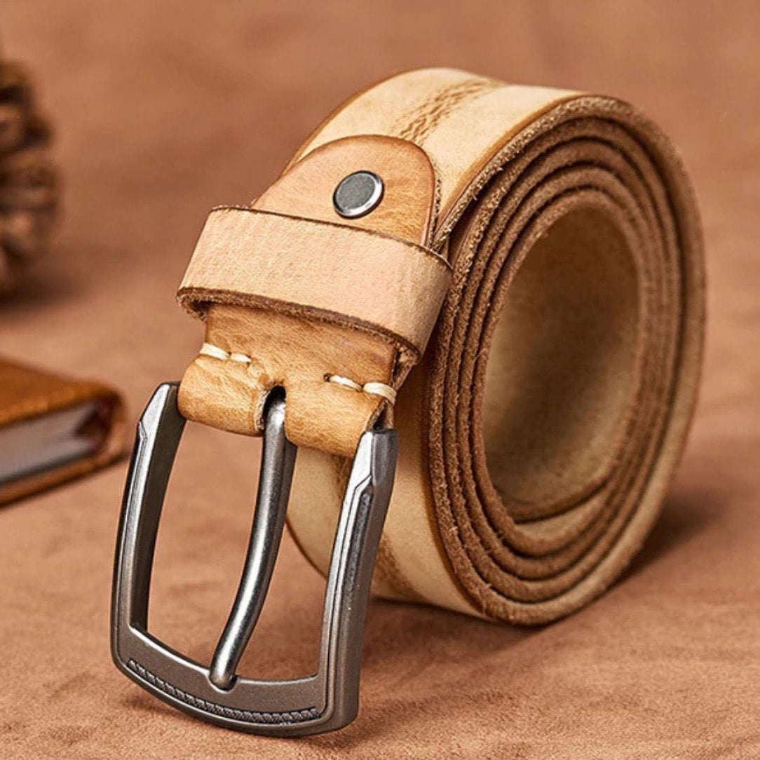 Rolled light brown leather belt with metal buckle.
