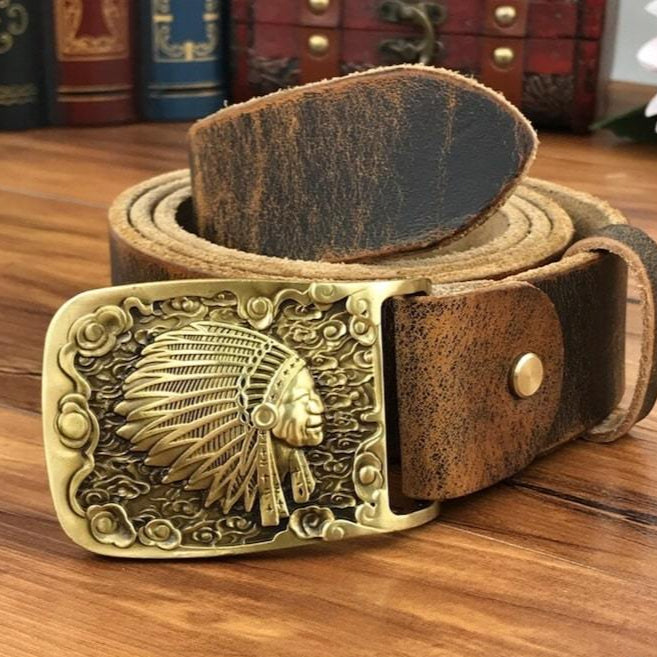 A leather belt with a gold-colored buckle featuring an Indian headdress.