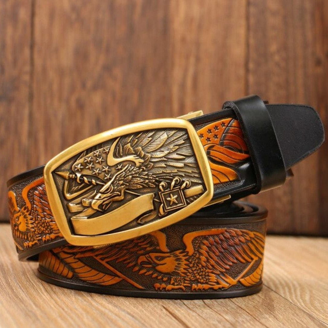 Brown leather belt with an eagle design and gold buckle.
