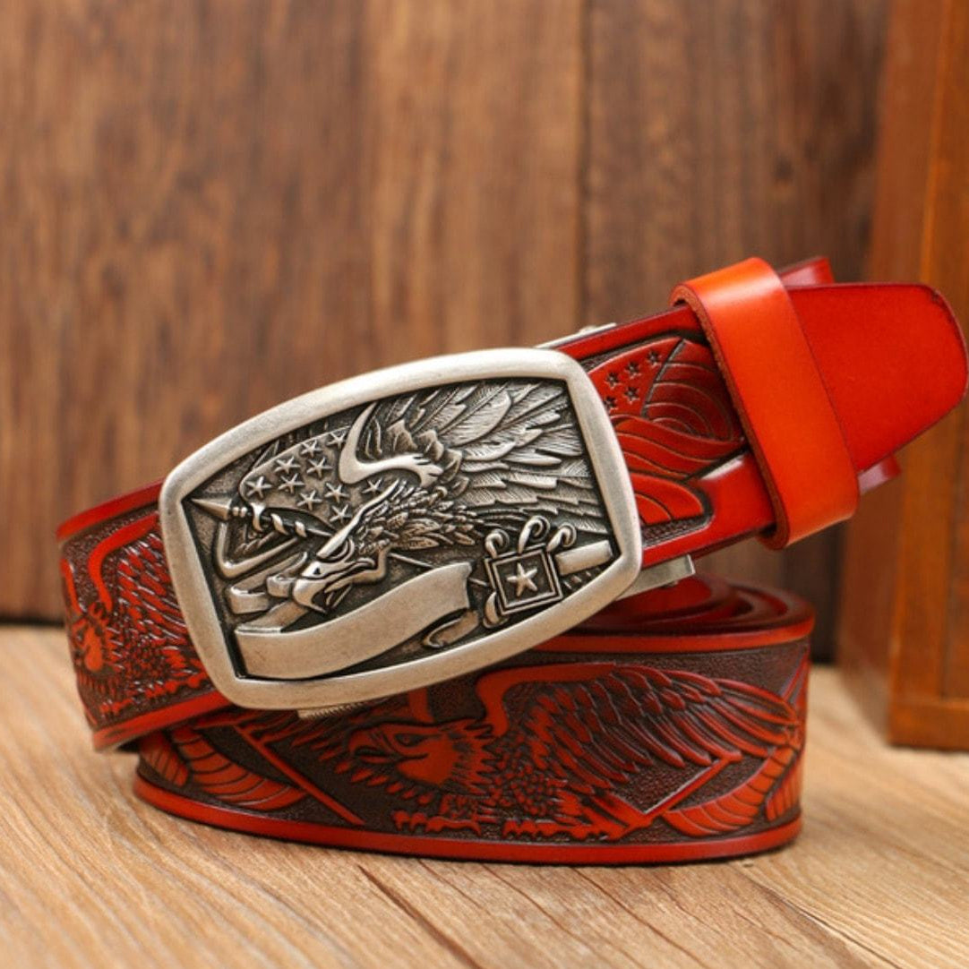 Red leather belt with a silver buckle featuring an eagle design.
