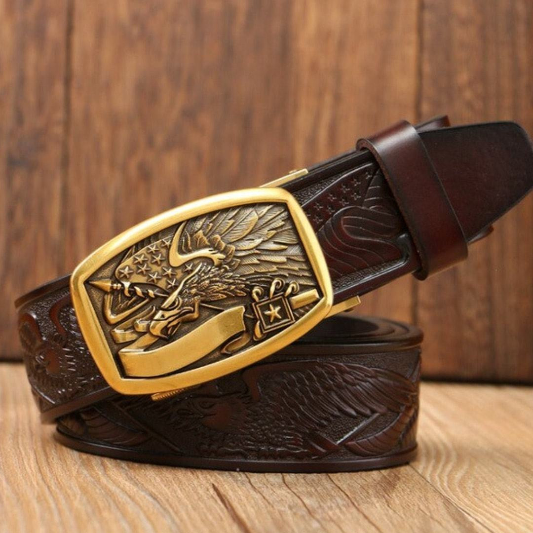 A brown leather belt with a golden buckle on a wooden surface.