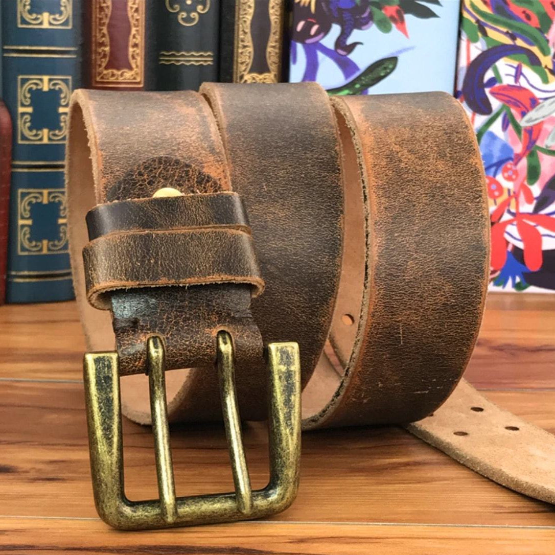 Brown leather belt with brass buckle.
