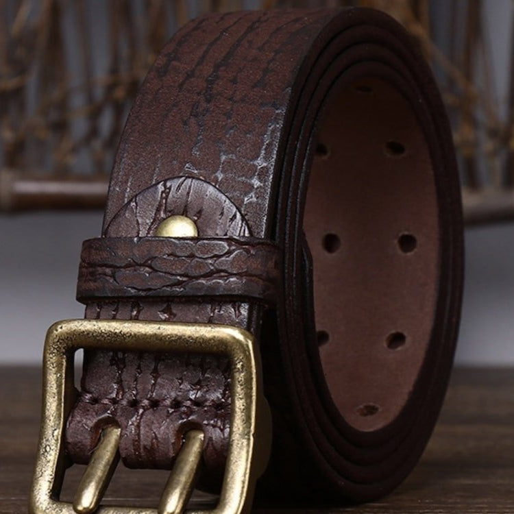 Rolled-up, brown, leather belt with a gold buckle.
