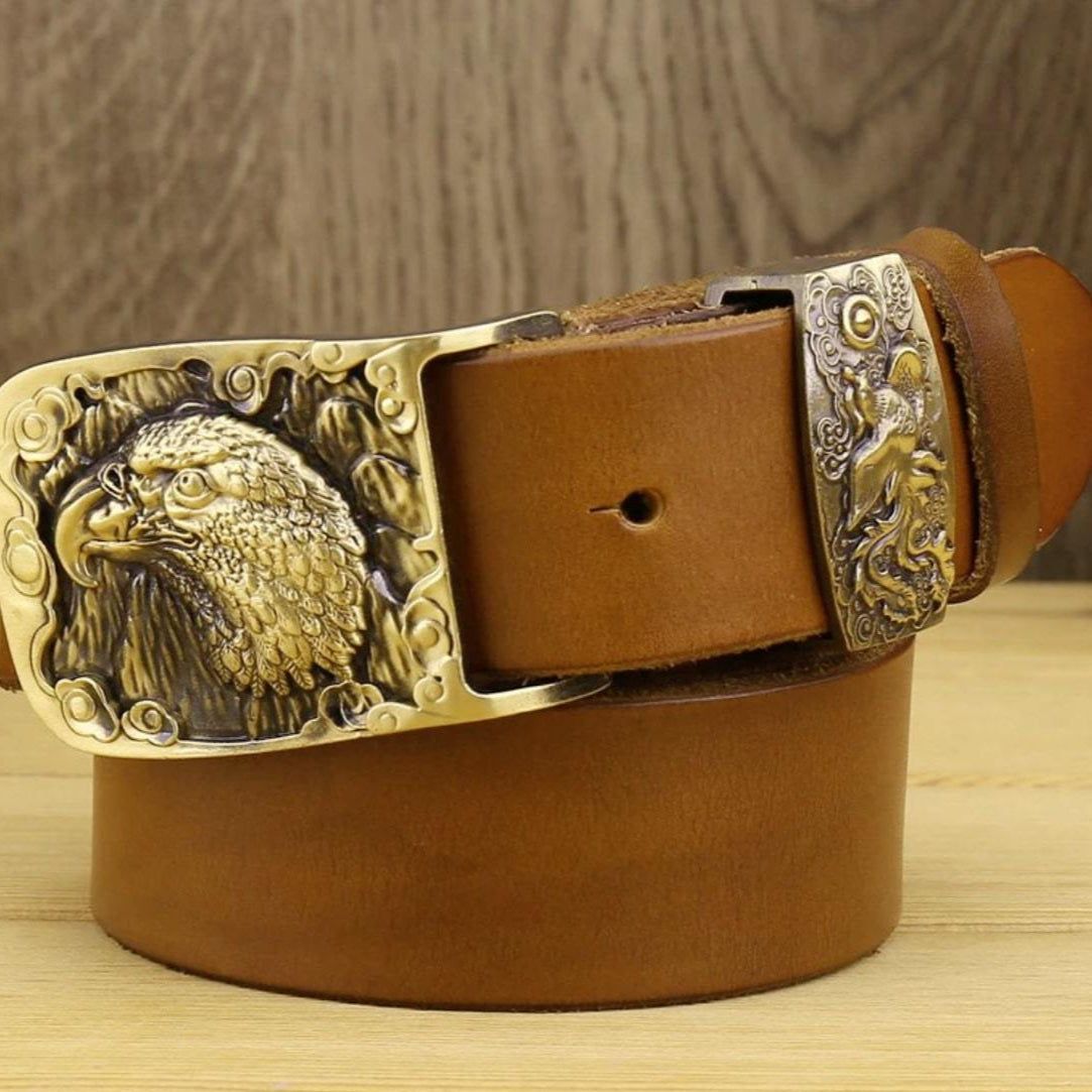 Close-up of a brown leather belt with an ornate gold eagle buckle.
