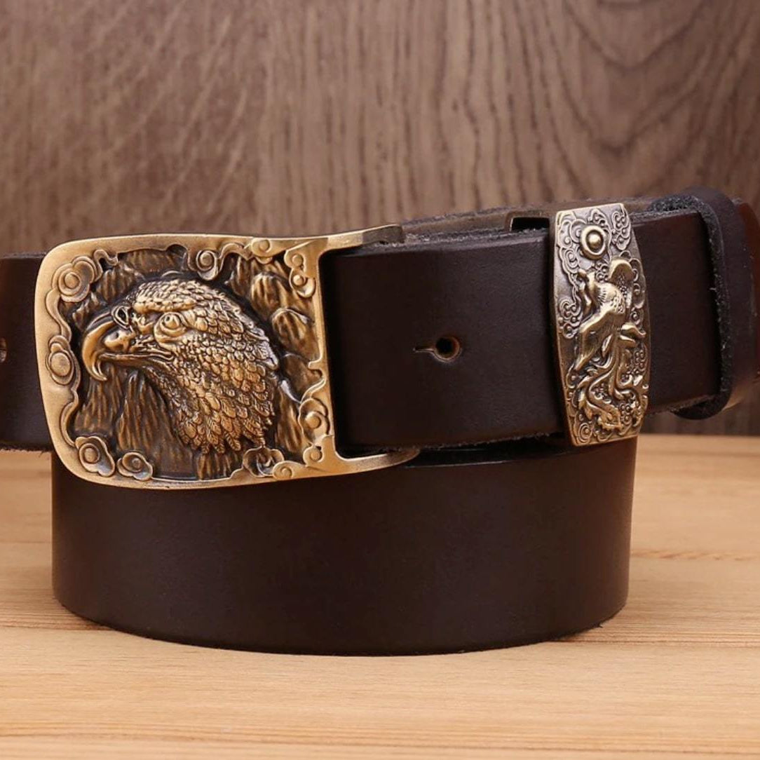 Close-up of a dark brown leather belt with an eagle buckle and a keeper with a figure.