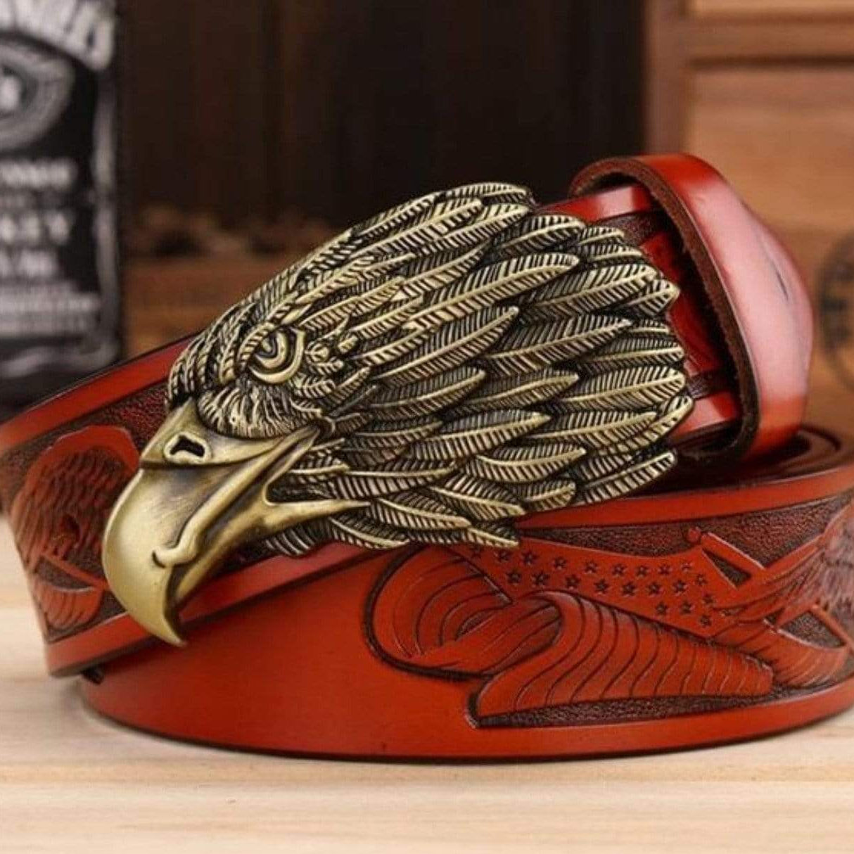 Red leather belt with bronze eagle buckle.
