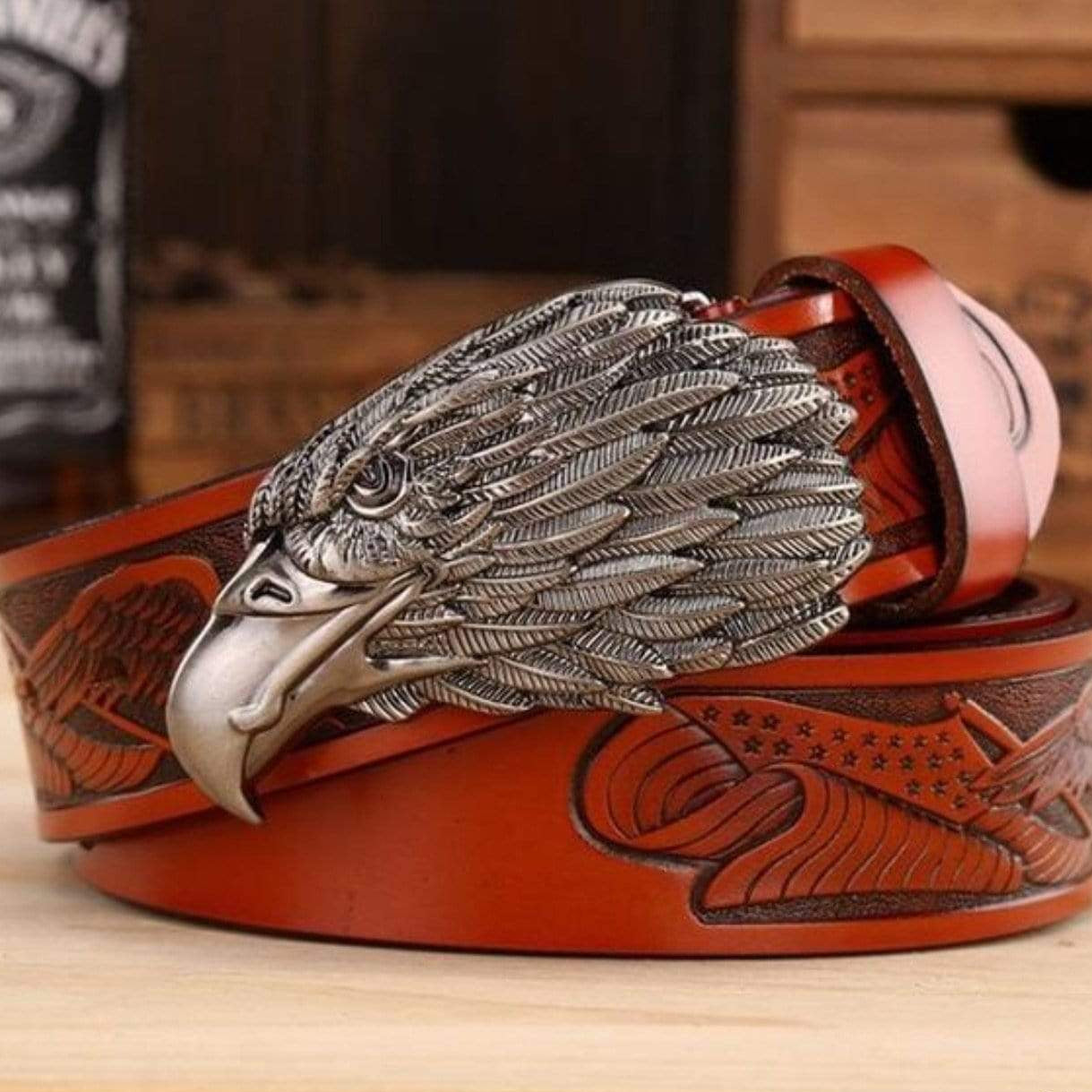 Red leather belt with silver eagle buckle and embossed American flag design.
