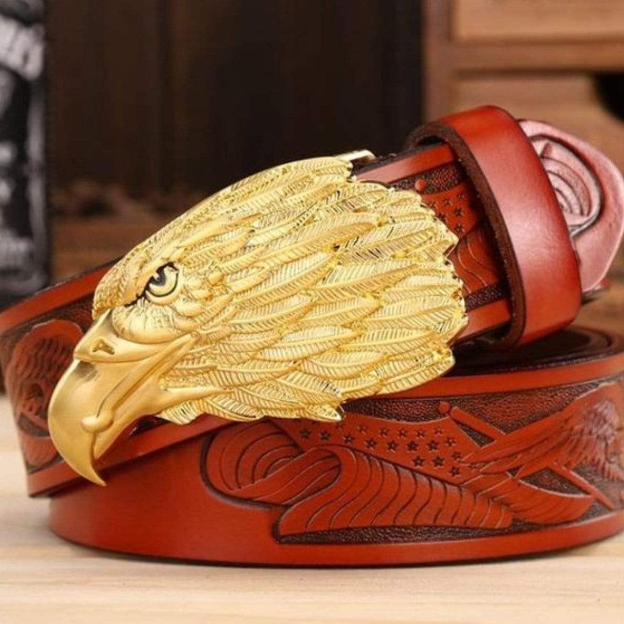 Brown leather belt with golden eagle buckle.