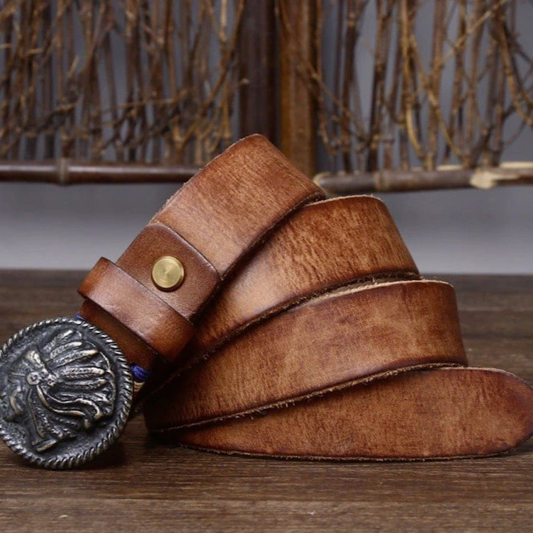 Brown leather belt with silver Native American-head buckle.