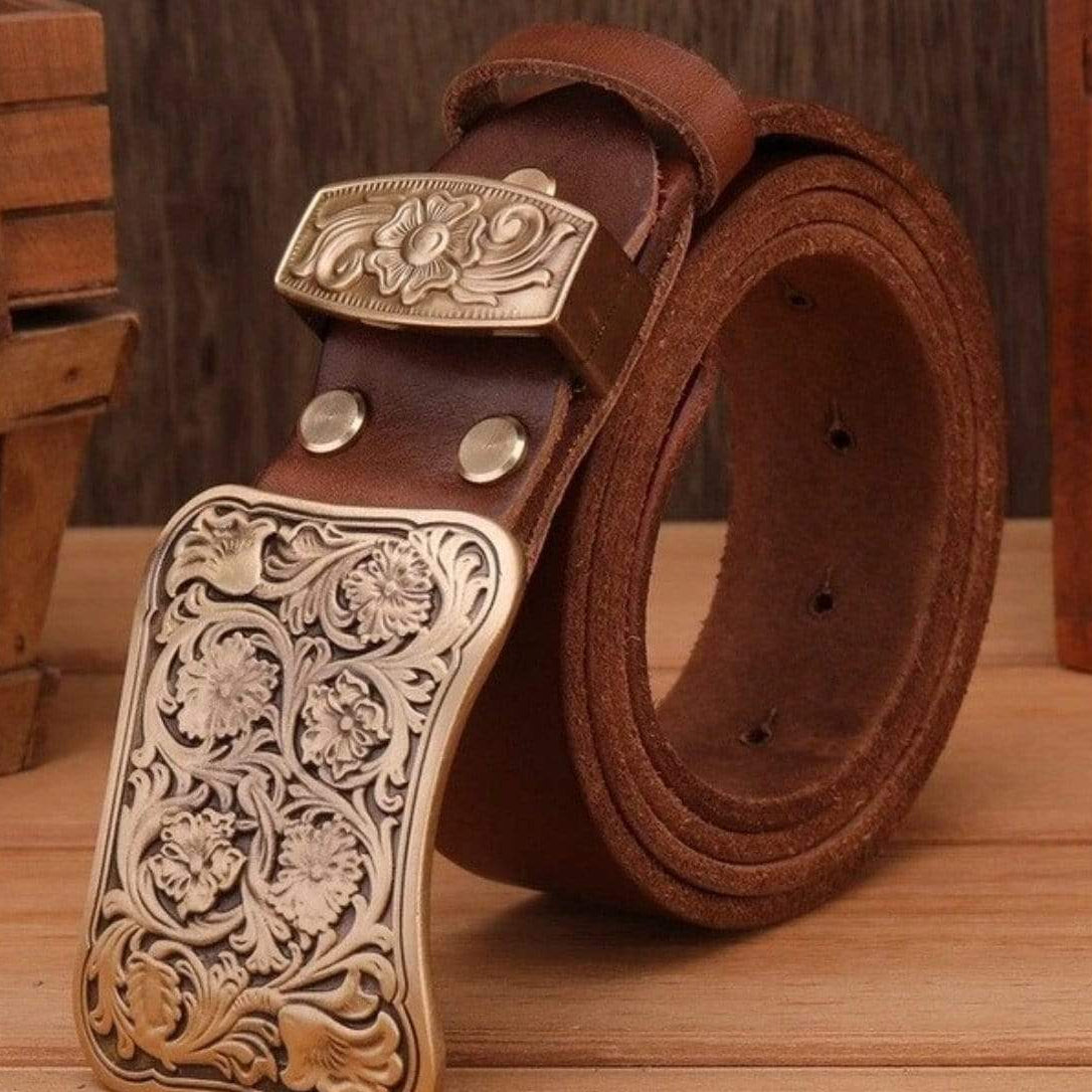 Close-up of a brown leather belt with a gold-colored floral buckle.