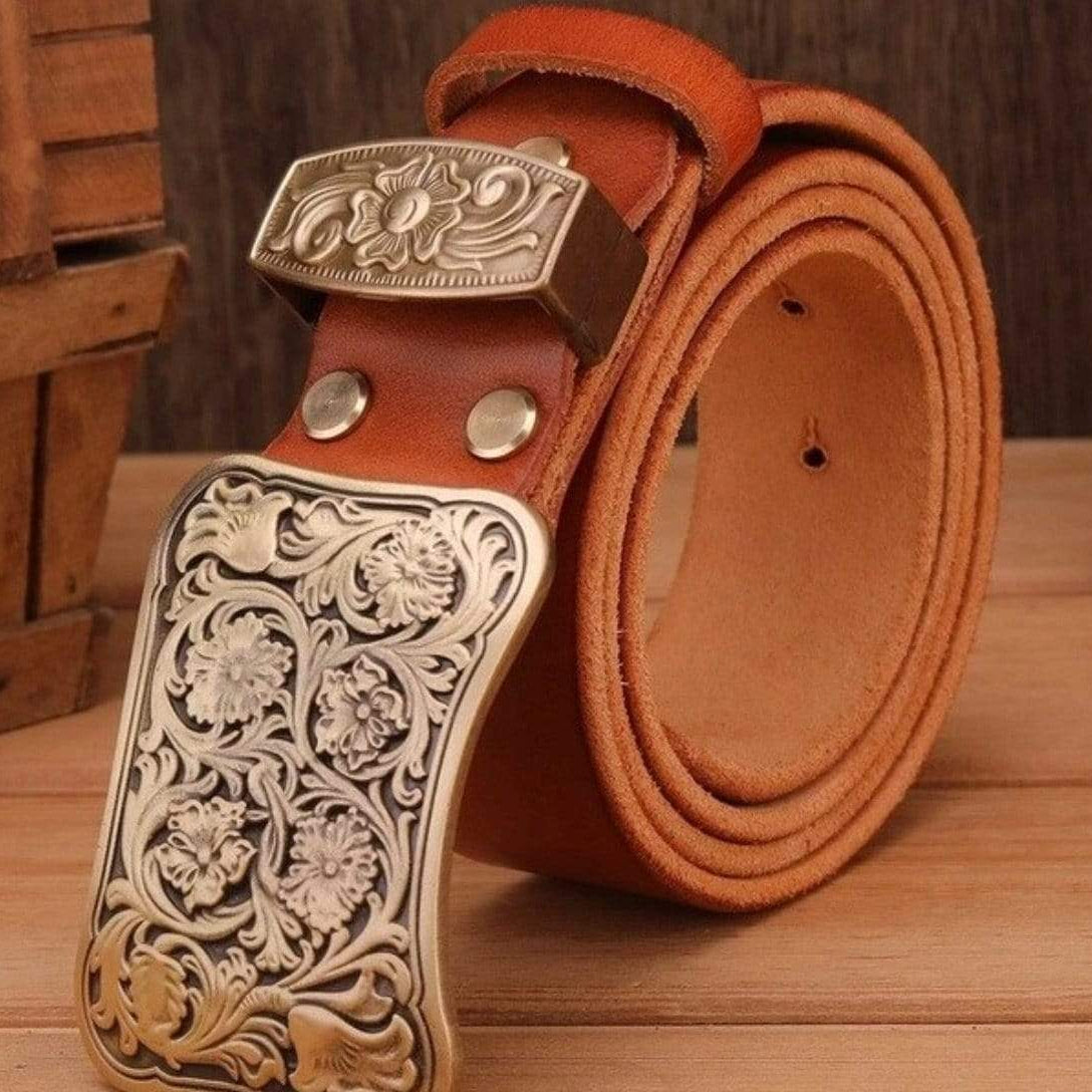 Brown leather belt with silver floral-patterned buckle.
