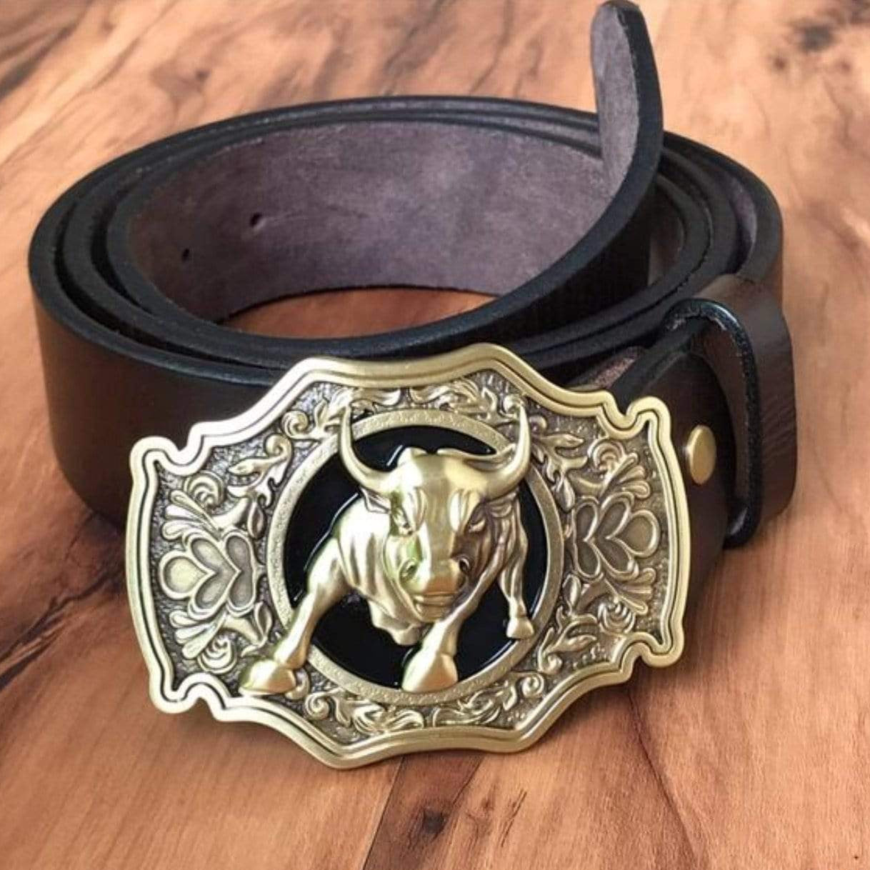 Black leather belt with a gold bull buckle.
