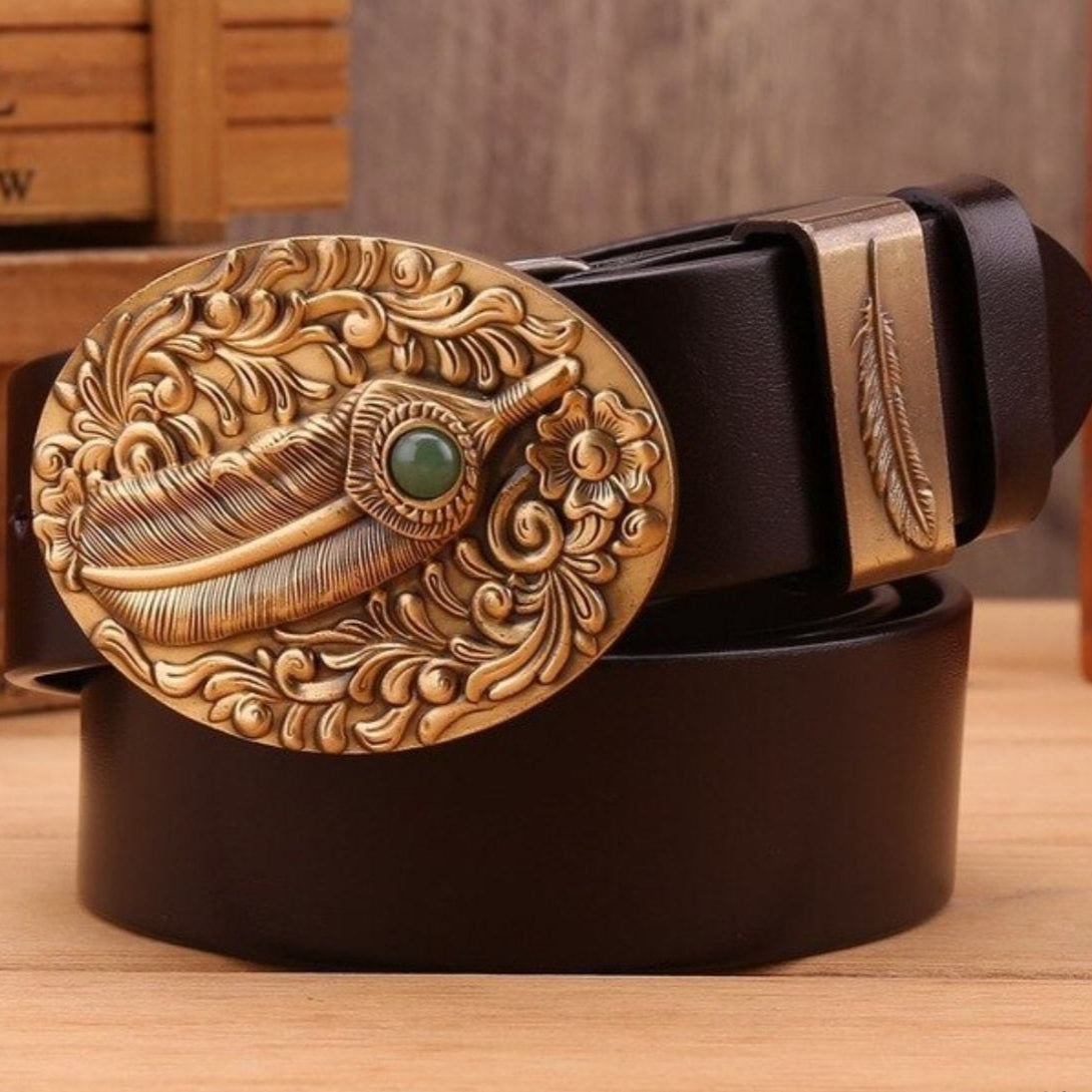 A leather belt with an ornate gold feather buckle and keeper.
