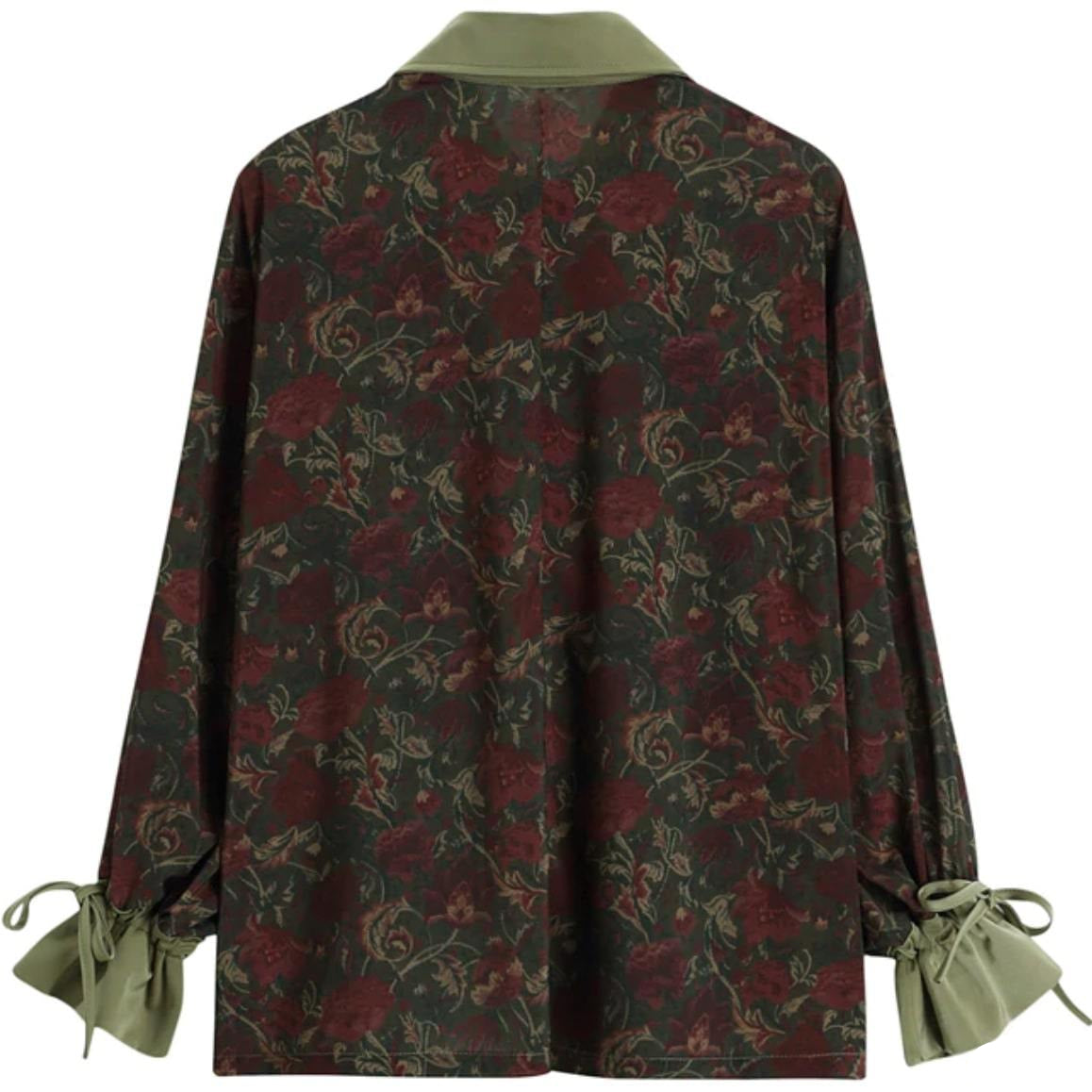 Back of floral print blouse with green collar and tie cuffs.