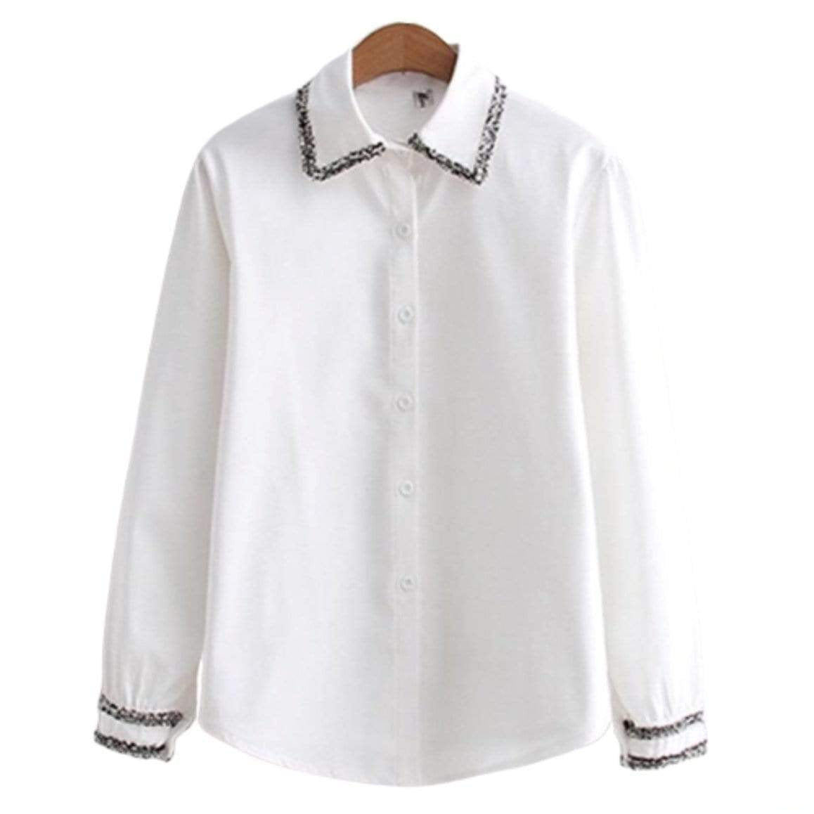 White collared long sleeve shirt with decorative collar and cuffs.