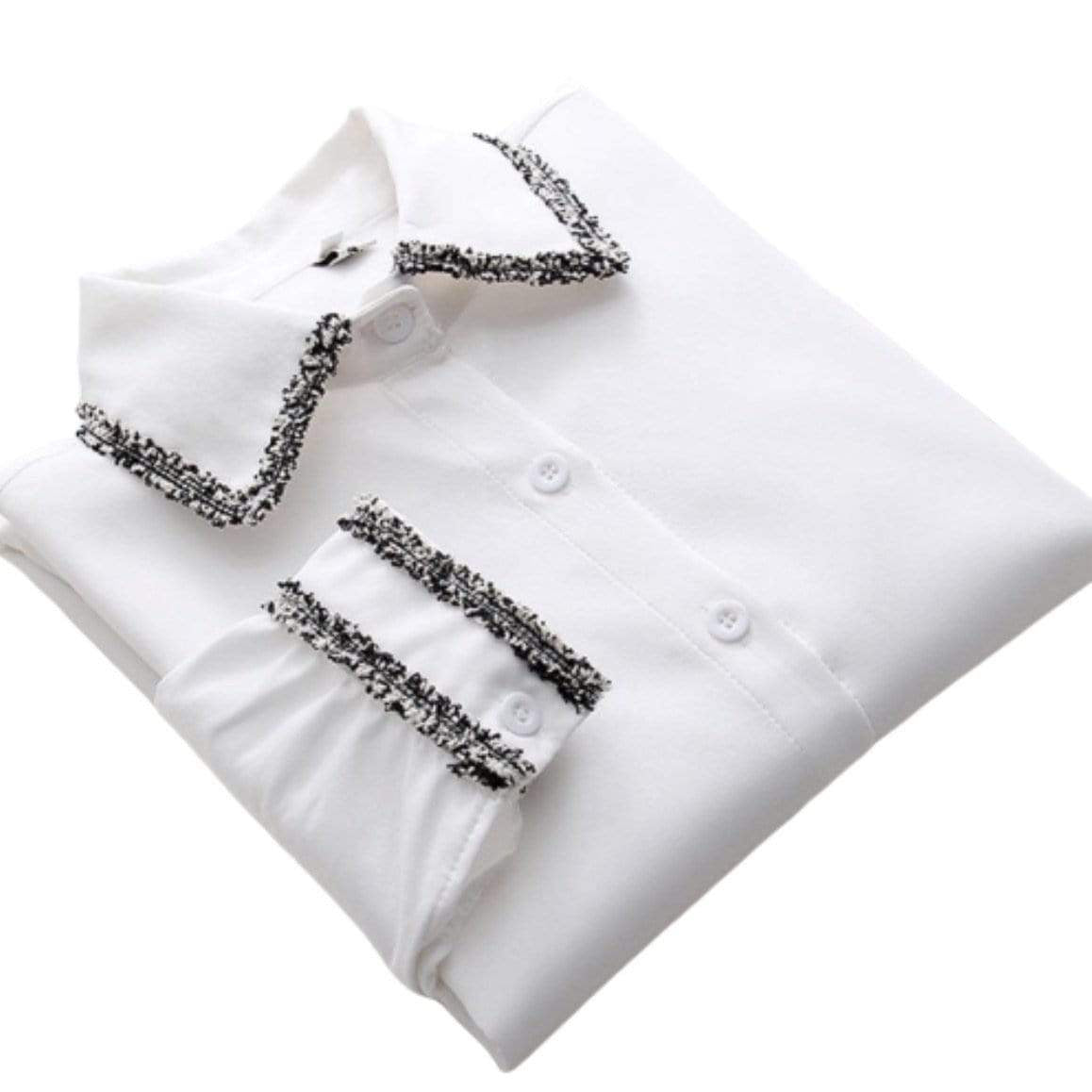 White blouse with black and white tweed trim on the collar and cuffs, buttoned down.
