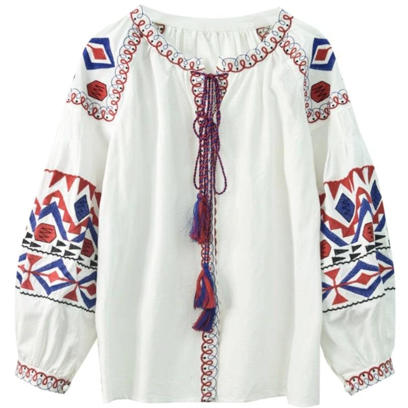 White blouse with red and blue embroidery, long sleeves, and tassel ties.