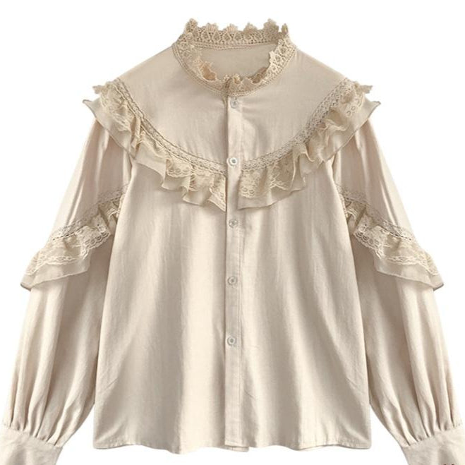 A beige blouse with frilly lace trim.
