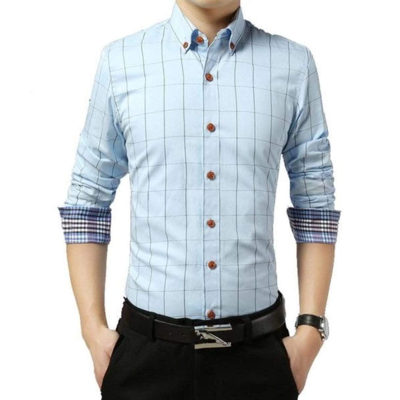 Man in light blue plaid shirt with brown buttons, black pants and belt, and watch.